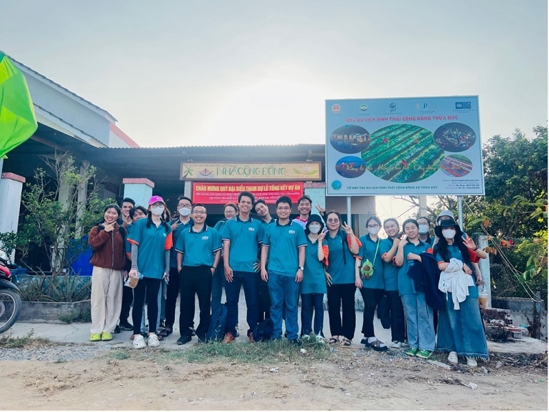 A group of people standing in front of a buildingDescription automatically generated